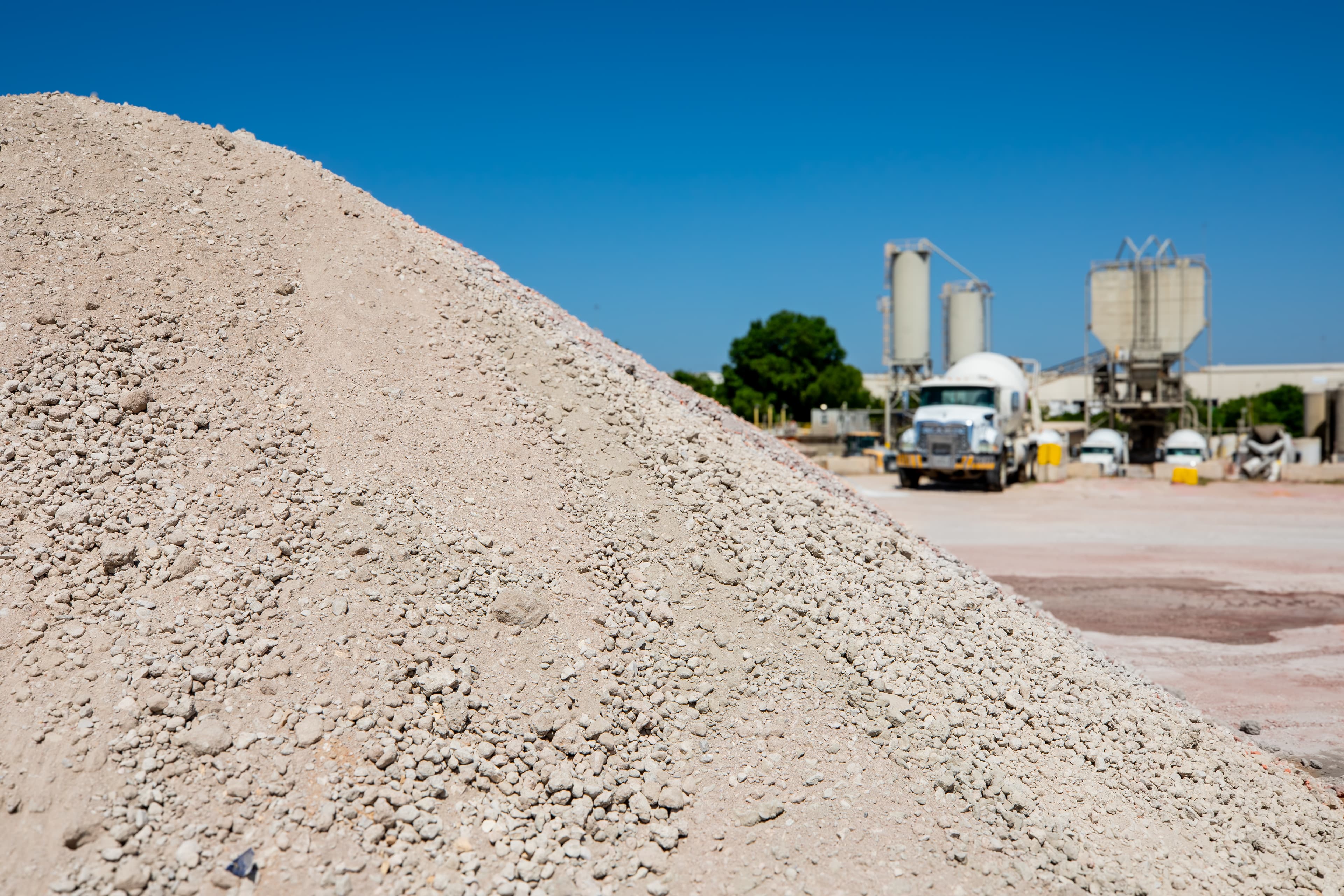 Washout material at the concrete plant with a truck and plant in the background