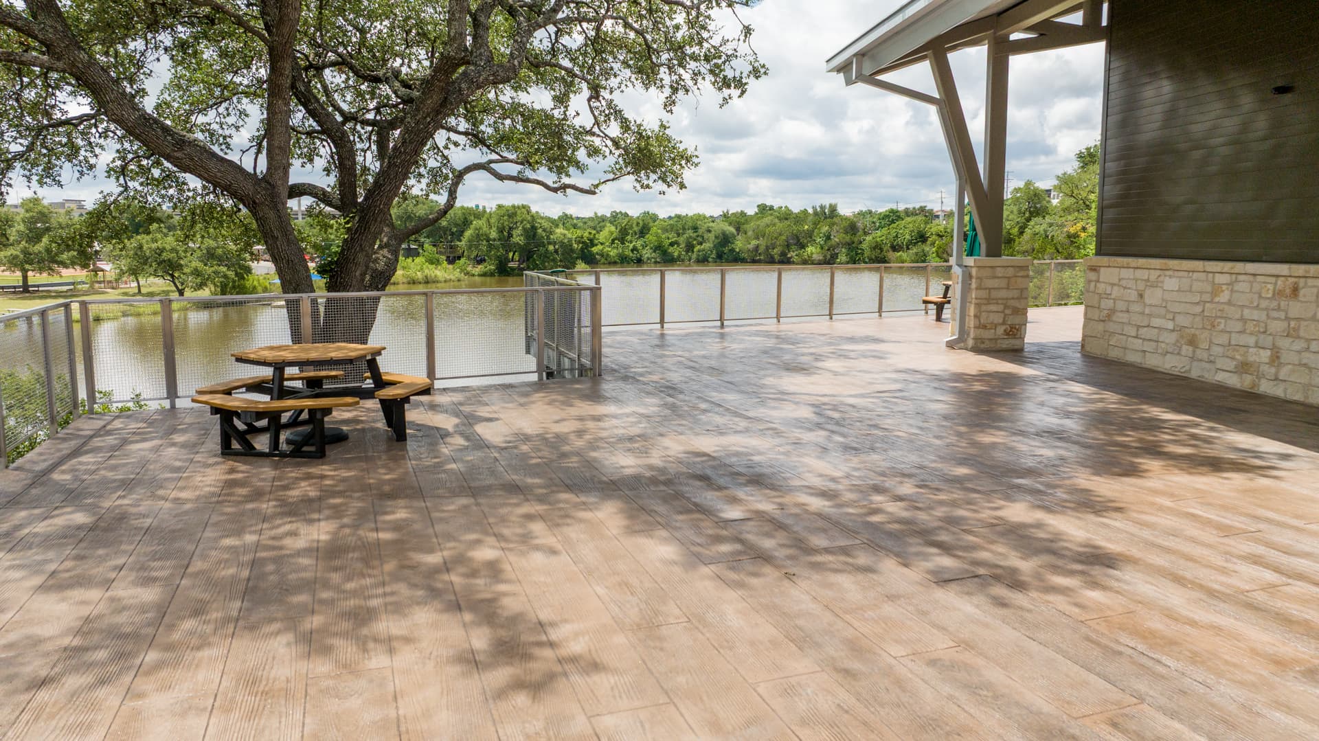 Stamped concrete made to look like wood on an outdoor deck overlooking the water