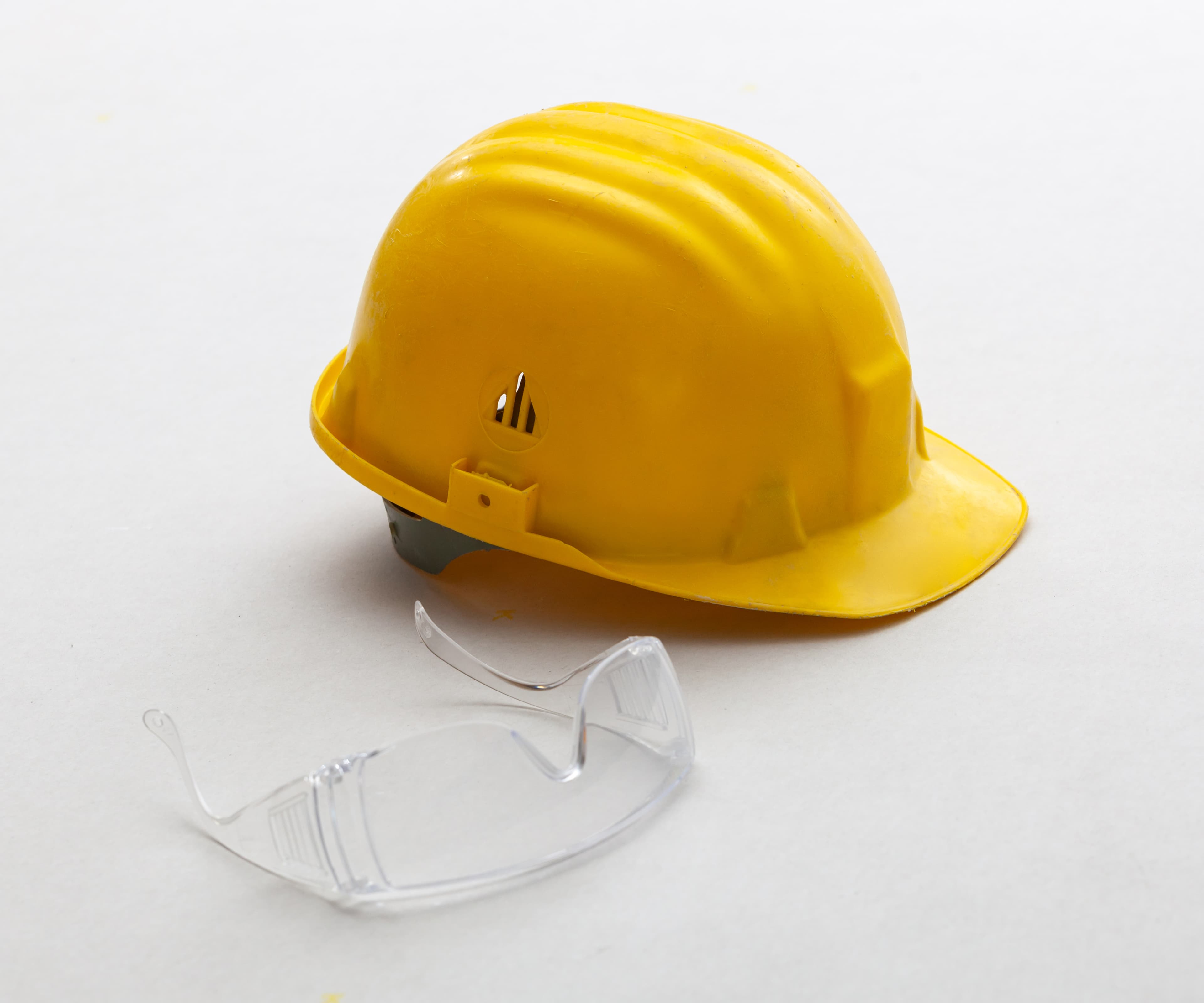 Yellow hard hat and safety glasses