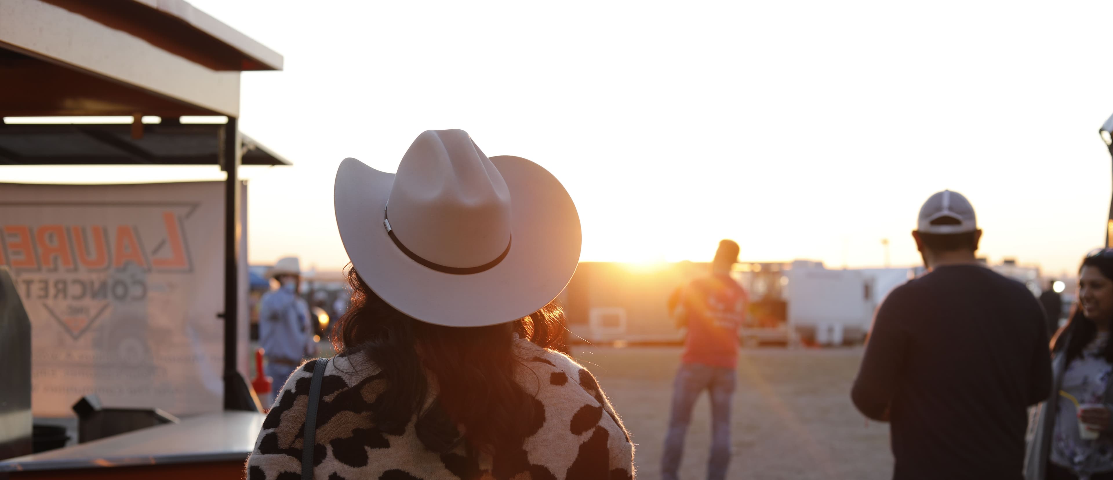 Sunset and a woman wearing a cowboy hat