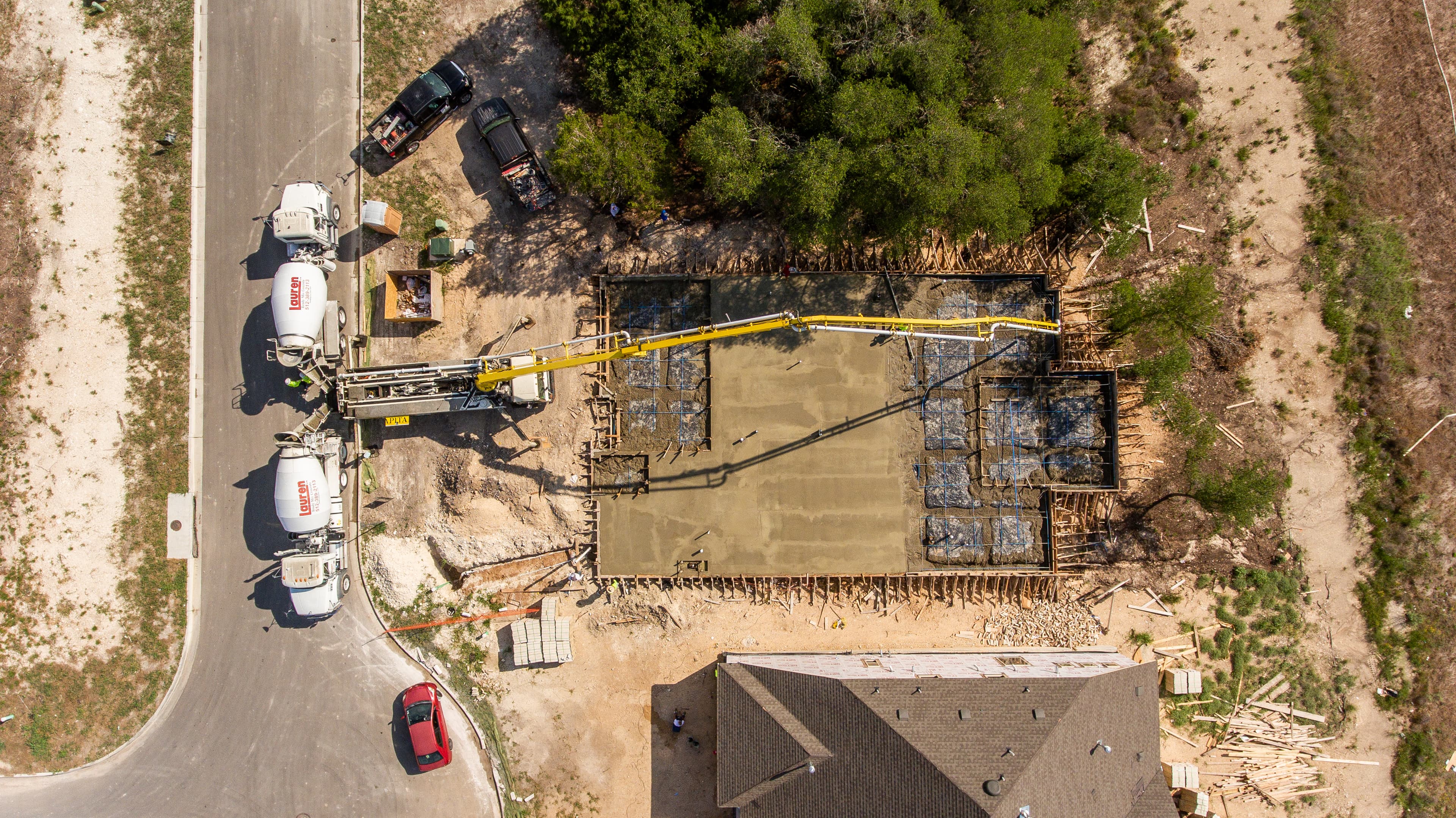 Lauren Concrete mixer trucks pouring fresh concrete for a house slab