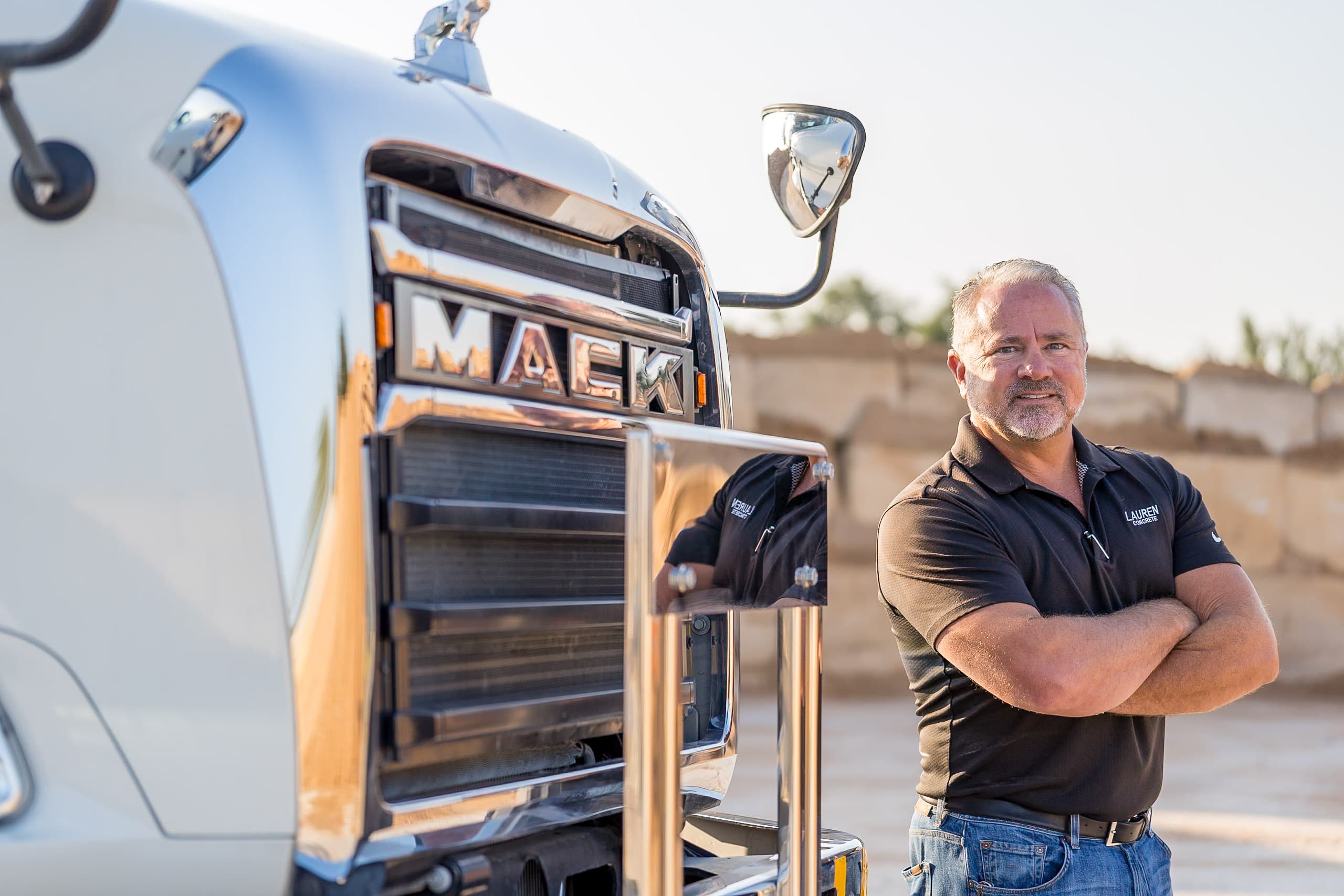 Ryan Bartholomew standing next to a ready-mix truck at the plant