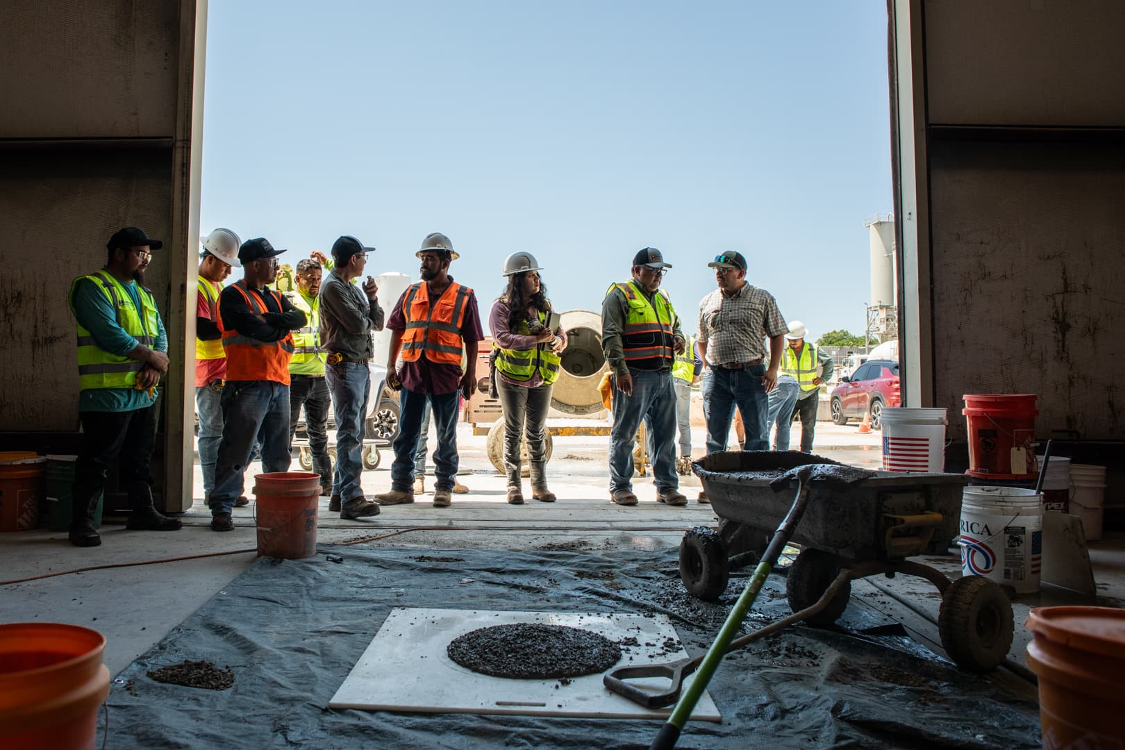 A group of people in the lab standing in front of a concrete spread